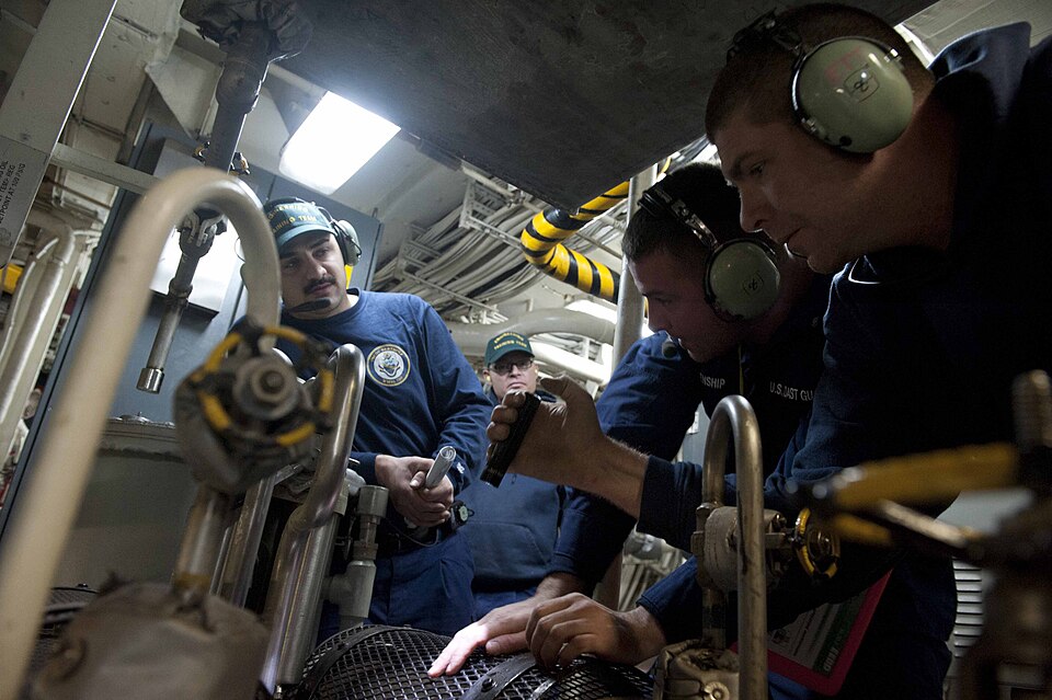 Maintenance technicians inspecting industrial machinery